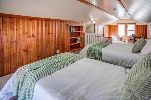 bedroom featuring wooden walls and vaulted ceiling with beams