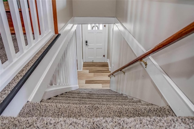 stairway with wood finished floors