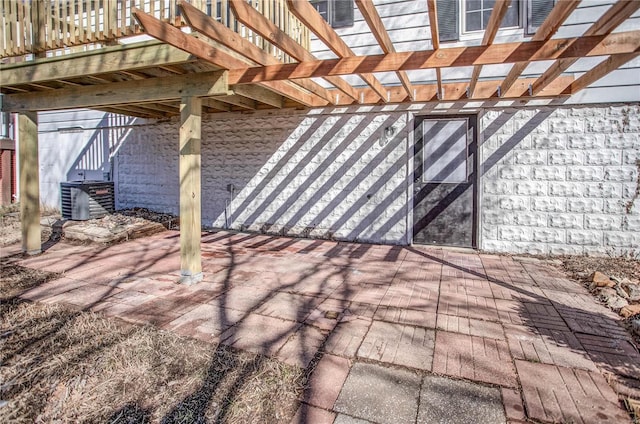 view of patio with cooling unit and a pergola