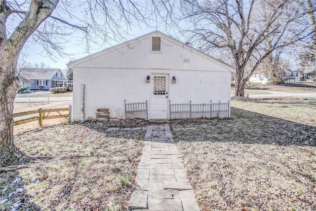 view of front of property with concrete block siding and fence