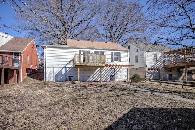 rear view of house with stairway, central AC unit, and a wooden deck