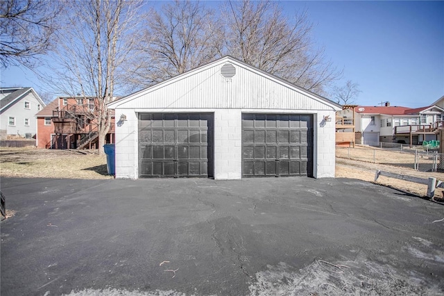 detached garage featuring fence