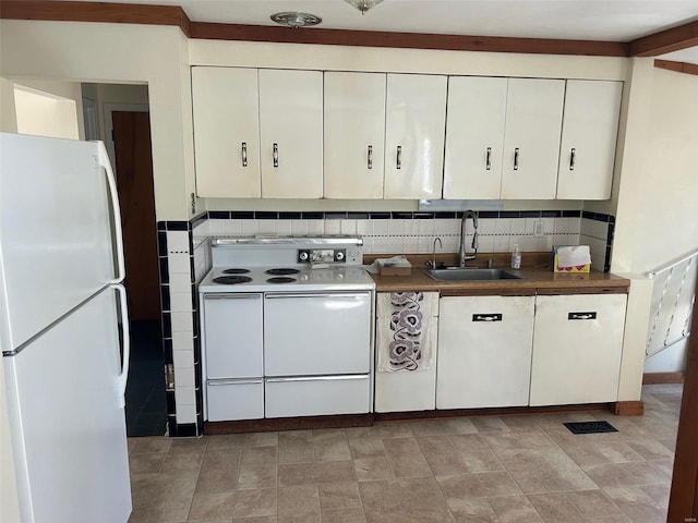 kitchen with decorative backsplash, white appliances, white cabinetry, and a sink