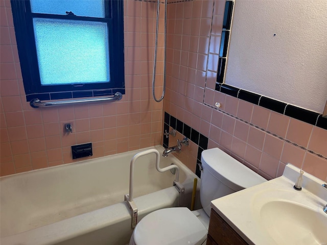 full bath featuring toilet, vanity, bathtub / shower combination, a textured wall, and tile walls