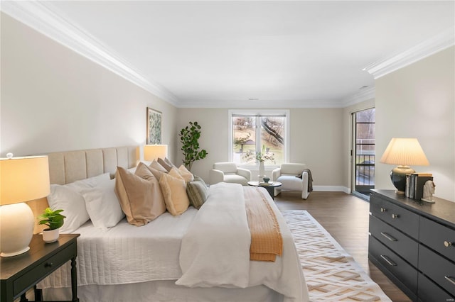 bedroom featuring ornamental molding, baseboards, and wood finished floors