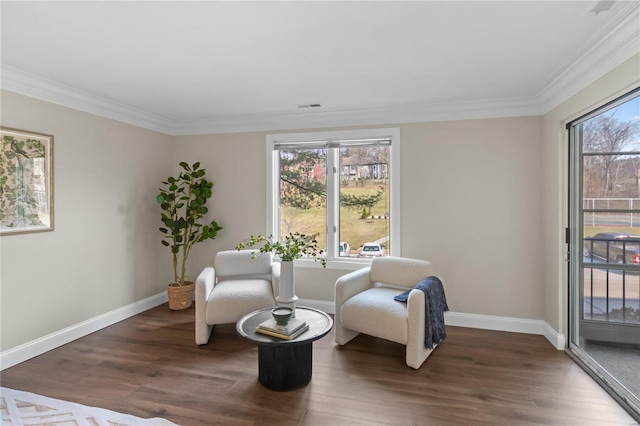 sitting room with wood finished floors, a healthy amount of sunlight, and baseboards