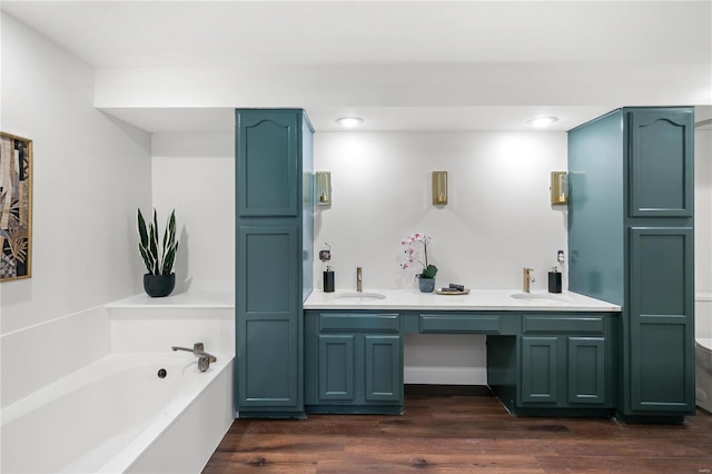 full bath featuring a sink, wood finished floors, and a bath