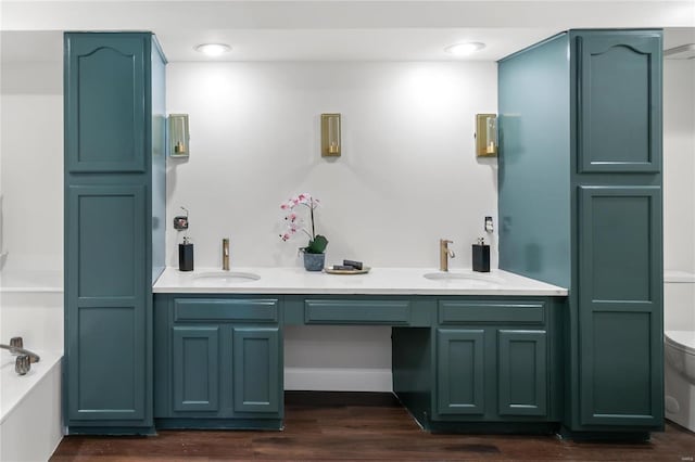 full bath featuring a bath, toilet, wood finished floors, and a sink