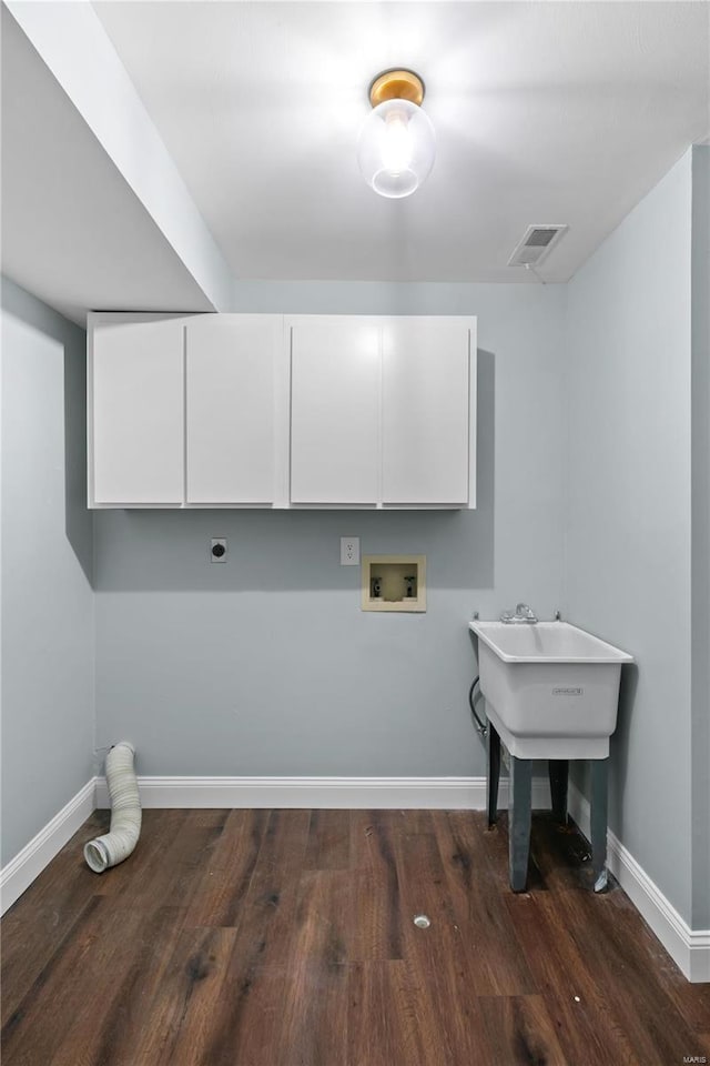 clothes washing area featuring wood finished floors, visible vents, hookup for an electric dryer, cabinet space, and washer hookup