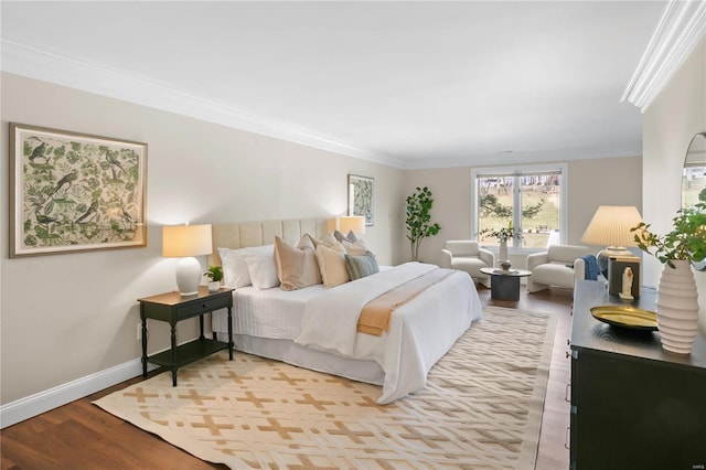 bedroom featuring baseboards, wood finished floors, and ornamental molding