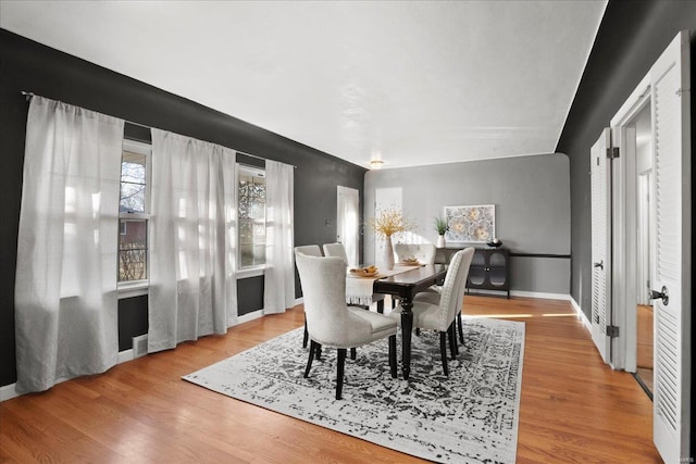 dining room with visible vents, baseboards, and wood finished floors