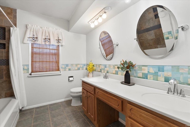 full bath with a sink, shower / tub combo, toilet, and double vanity