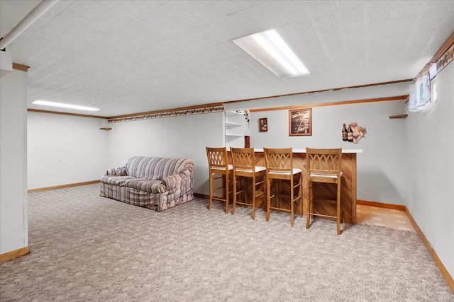 interior space with a dry bar, baseboards, and carpet floors