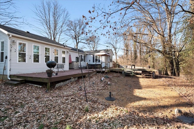 rear view of property featuring a wooden deck