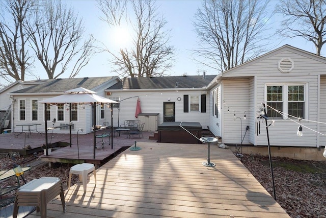 back of house with a wooden deck and a hot tub