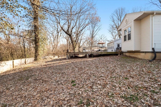 view of yard featuring a deck and fence