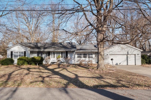 view of front of home with a front yard, a garage, and driveway