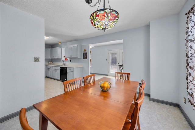 dining room with baseboards and a textured ceiling