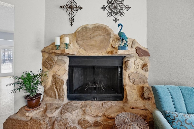 interior details featuring a stone fireplace
