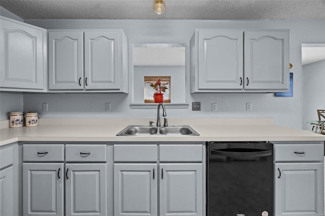 kitchen with black dishwasher, a sink, and white cabinets