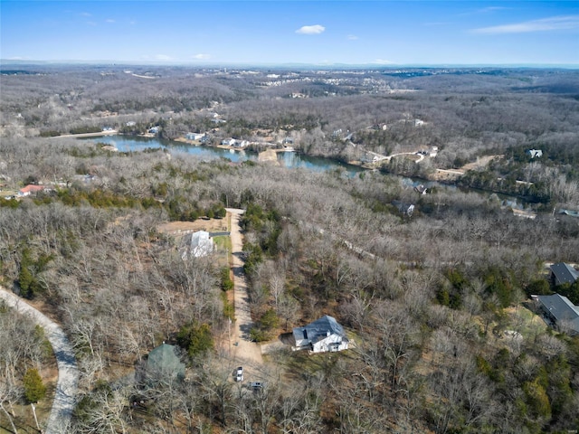 aerial view featuring a water view and a wooded view