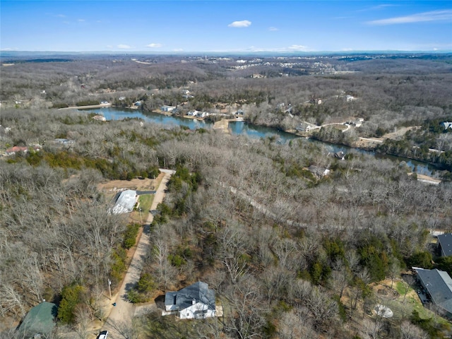 aerial view with a water view and a wooded view