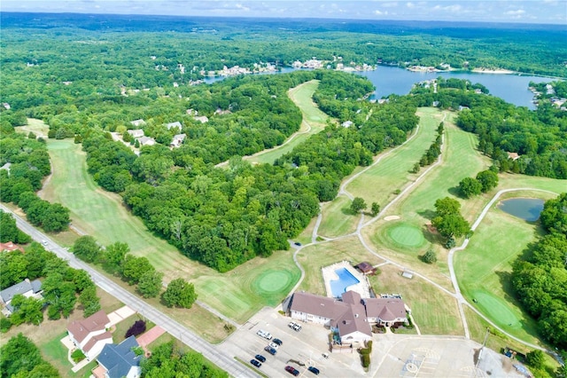 drone / aerial view featuring a water view and a wooded view