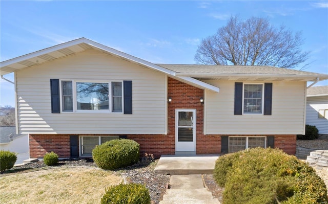 bi-level home featuring brick siding