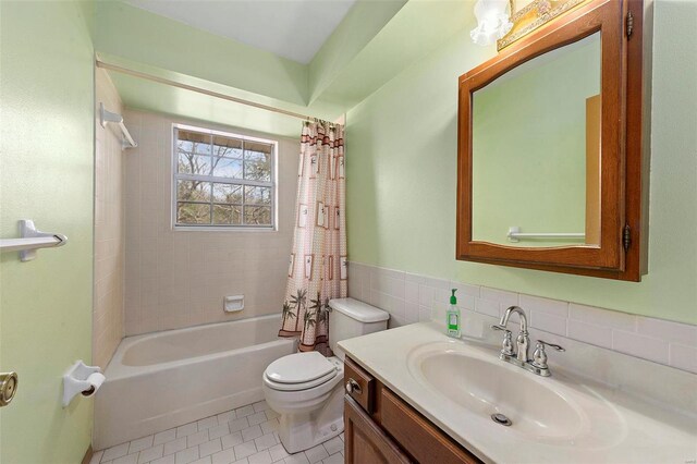 full bathroom featuring toilet, shower / bath combination with curtain, tile walls, tile patterned flooring, and vanity
