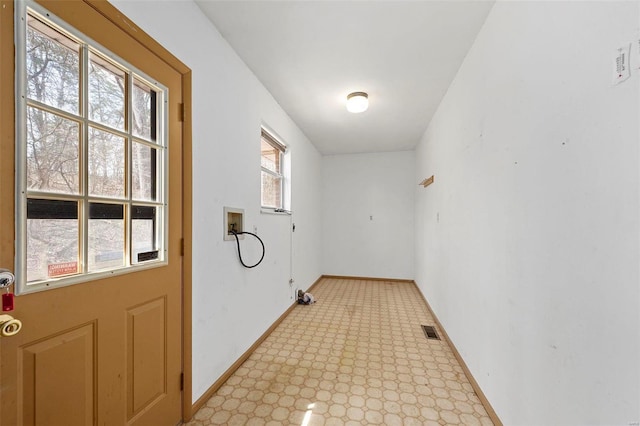 doorway with visible vents, baseboards, and light floors