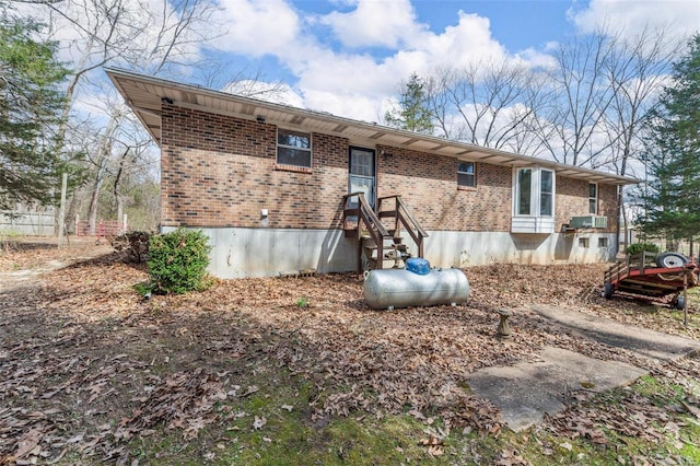rear view of property featuring brick siding