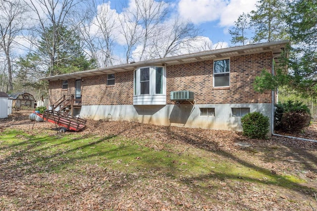 rear view of house with brick siding and central AC unit