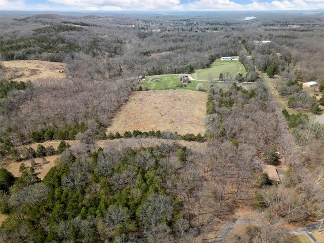 bird's eye view featuring a wooded view