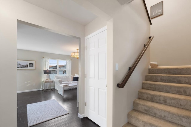 stairs with baseboards and wood finished floors