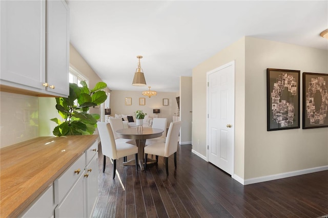 dining room with baseboards and dark wood-style flooring