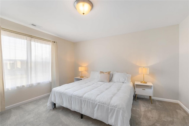 carpeted bedroom with visible vents and baseboards