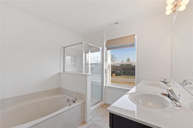 bathroom featuring a sink, visible vents, a garden tub, and a stall shower