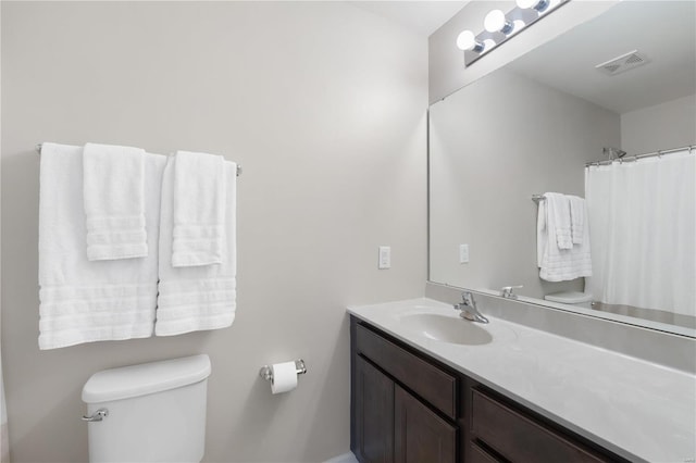 full bath with visible vents, toilet, and vanity