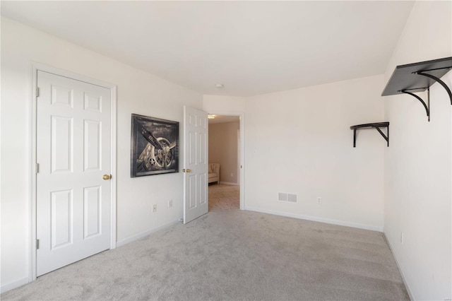 unfurnished bedroom featuring visible vents, baseboards, and carpet flooring