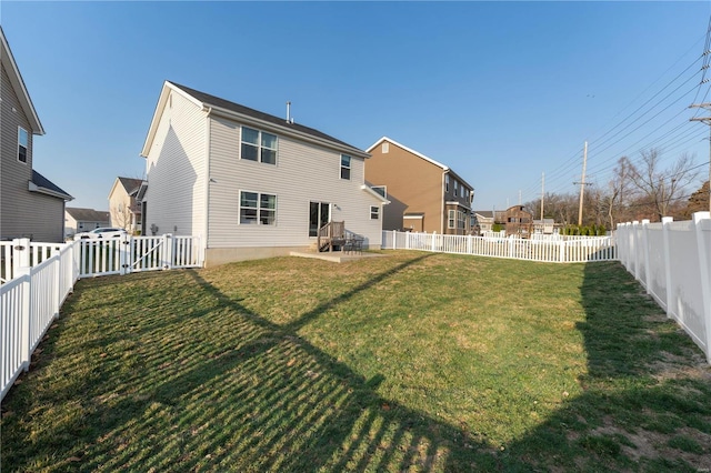 back of property with a yard and a fenced backyard