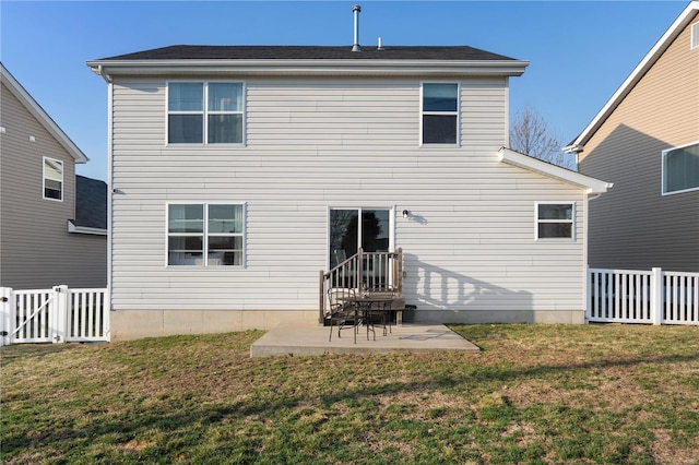 rear view of property with fence, a lawn, and a patio area