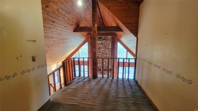 hallway featuring wooden ceiling, high vaulted ceiling, carpet, and baseboards