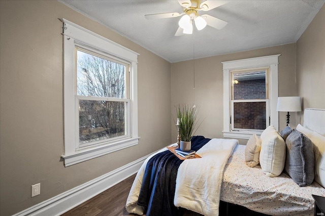 bedroom featuring baseboards, dark wood-style flooring, and ceiling fan