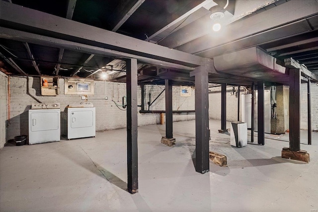 unfinished basement with gas water heater and independent washer and dryer