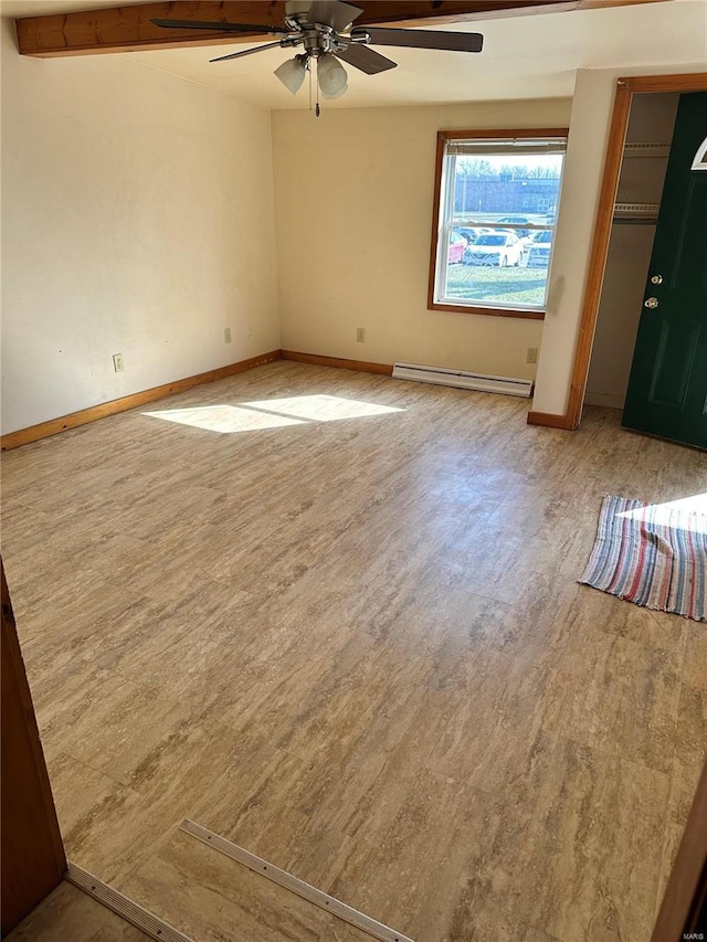 unfurnished room with baseboards, baseboard heating, and wood finished floors