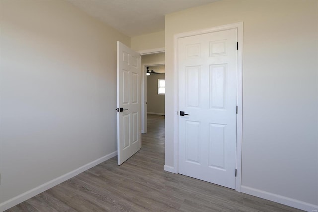 unfurnished bedroom featuring baseboards and wood finished floors