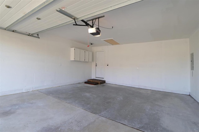 garage with electric panel and a garage door opener