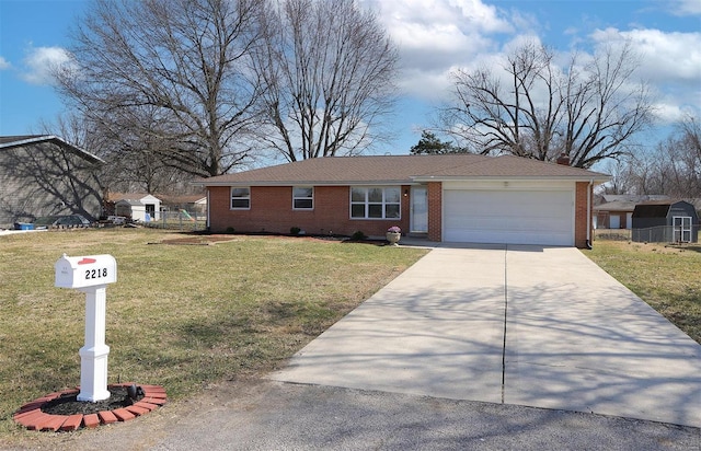 ranch-style home with a front yard, a garage, brick siding, and driveway