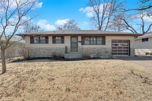 ranch-style home with stone siding, driveway, and a garage