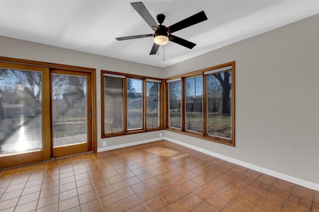 unfurnished sunroom featuring a ceiling fan